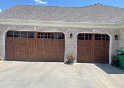 Nice home with brick exterior and dark brown stained wooden garage