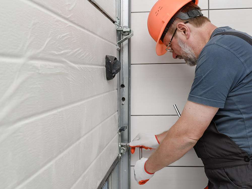 a person repairing a garage door 